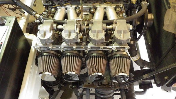 Four Keihin CR Special 35mm carburetors with K&N filters on a Triumph Spitfire engine