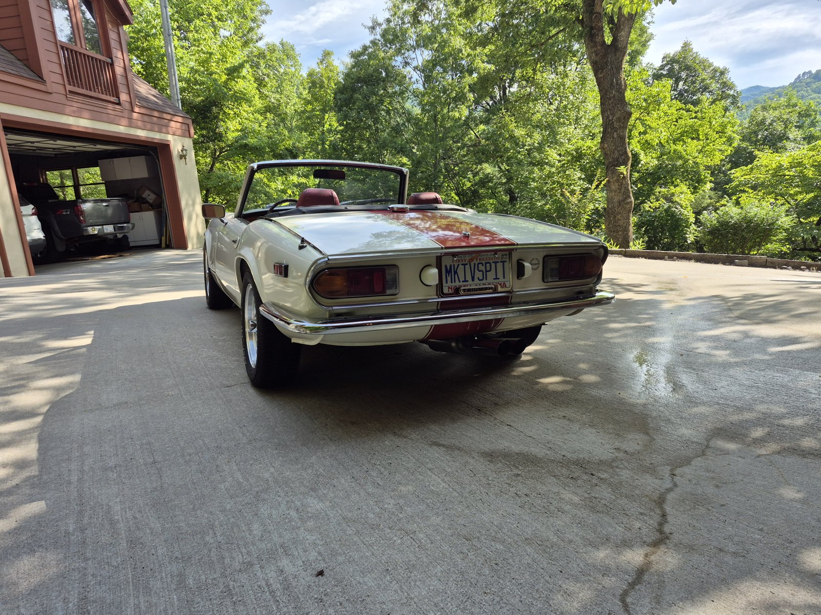 Rear view of a Triumph Spitfire Mk IV with a MKIVSPIT license plate